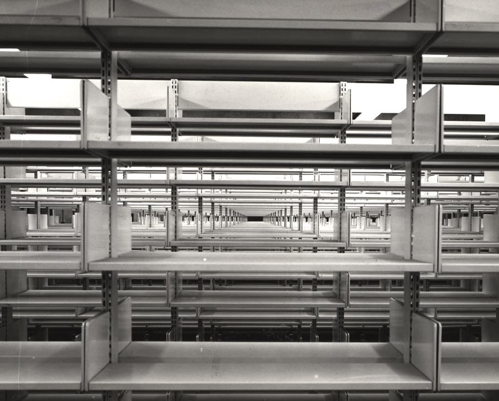Empty library shelves after a collection was cleared out